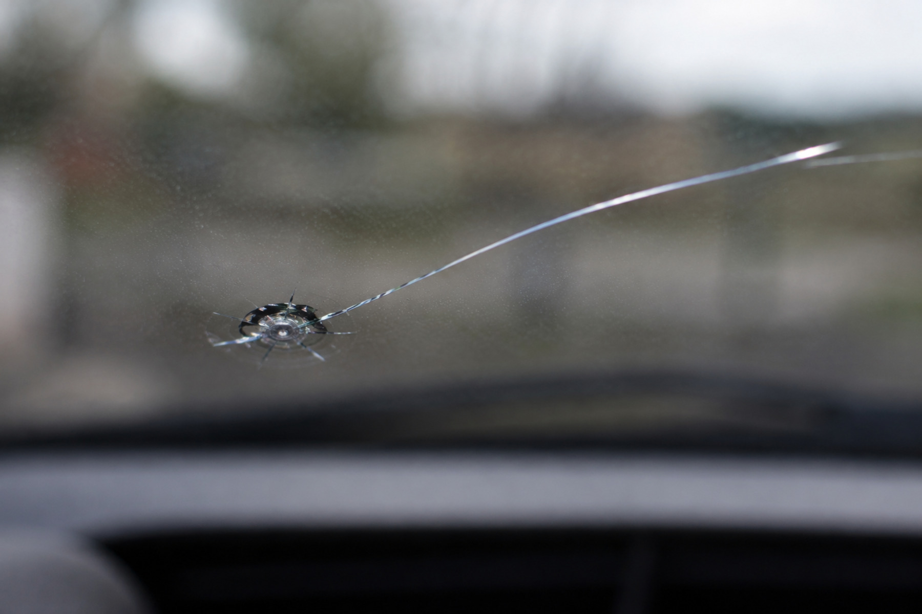 Side-by-side comparison of a small windscreen chip and the same chip with a crack running from it